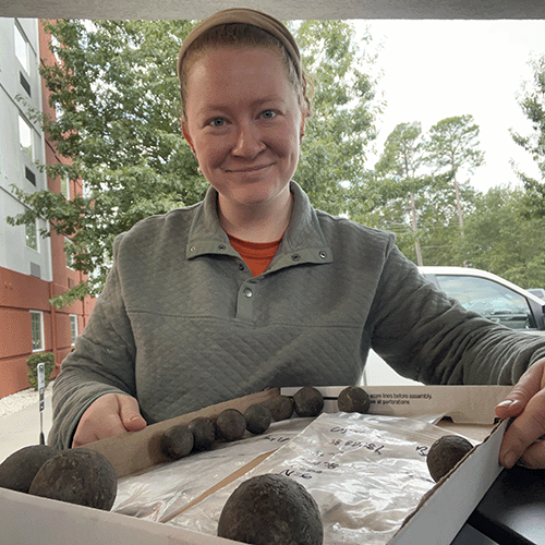 Lauren Scott with artifacts from a site.