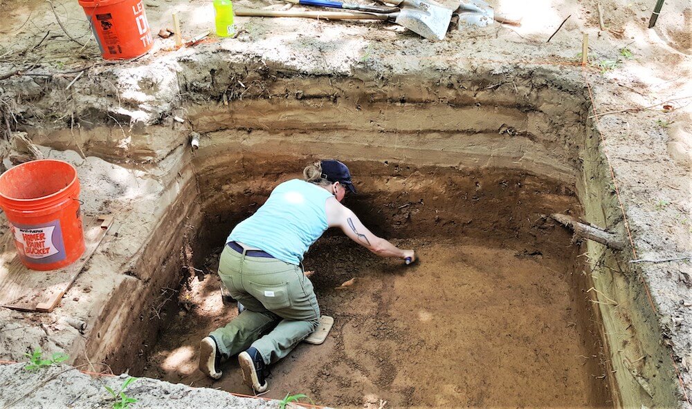 An archaelogist digging.